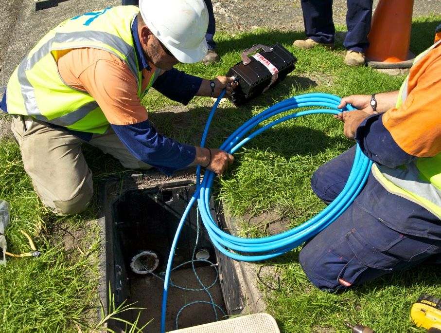Workers lay fibre-optic cable as part of the NBN rollout. 